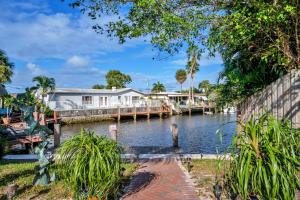 a body of water with a house and a dock at Purely Pompano, Pool, Water front, Paddleboard, Beach, 5 bedroom 3 bath in Pompano Beach