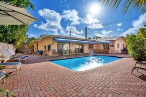 a swimming pool in front of a house at Purely Pompano, Pool, Water front, Paddleboard, Beach, 5 bedroom 3 bath in Pompano Beach