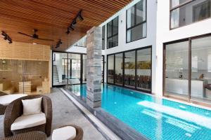 a swimming pool in the middle of a house at My Khe Beach Villa in Da Nang
