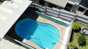 an overhead view of a swimming pool in a building at Spacious 4-bdrm fully self-contained WIFI, Parking in Suva