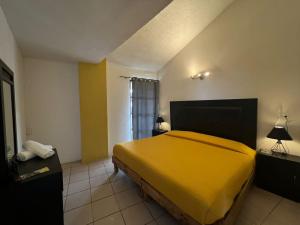 Postel nebo postele na pokoji v ubytování Hotel Quinta Luna Zacatlán