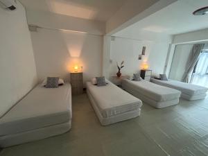a room with three beds and two tables at Monkey Toe Guesthouse in Chiang Mai +61 photos
