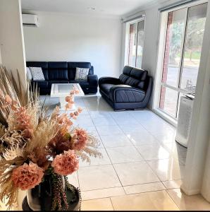 a living room with a couch and a table at Luxurious Family Home in Sydenham