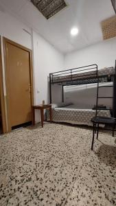 a room with two bunk beds and a door at Pension Suiza in Reus