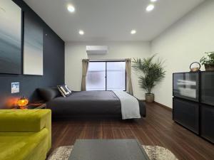 Postel nebo postele na pokoji v ubytování guesthouse Nakatsu