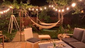 a hammock in the middle of a garden at night at Casa individuala cu gradina in Botoşani