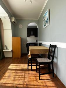 a dining room and kitchen with a table and chairs at Apartment on Agrba in Pizunda