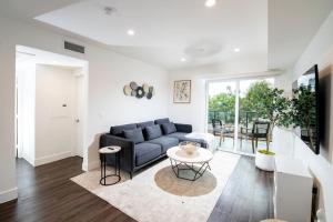 a living room with a couch and a table at Luxury 2Bed/2Bath Apt in West Hollywood w/ Rooftop in Los Angeles