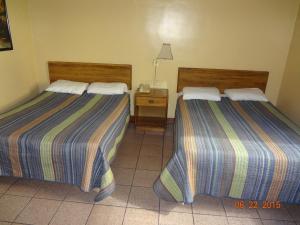 Ein Bett oder Betten in einem Zimmer der Unterkunft Hotel Olivia