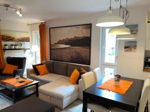 a living room with a couch and a table at Apartament Marcin in Międzywodzie