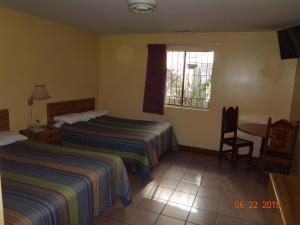 Ein Bett oder Betten in einem Zimmer der Unterkunft Hotel Olivia