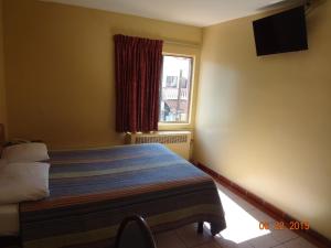 Ein Bett oder Betten in einem Zimmer der Unterkunft Hotel Olivia