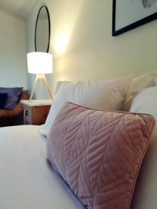 a bedroom with a bed with a pillow on it at Karriview in Gracetown