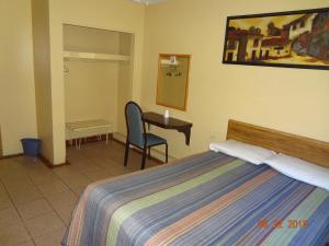 Ein Bett oder Betten in einem Zimmer der Unterkunft Hotel Olivia