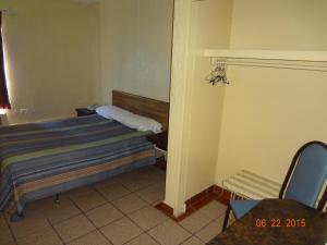 Ein Bett oder Betten in einem Zimmer der Unterkunft Hotel Olivia