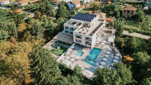 an aerial view of a house with a swimming pool at Hotel Green Park Service Perfected in Garmen