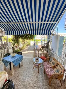 un patio con tavolo e ombrellone blu di Casa vacanza Salento, Santa Maria al Bagno a Galatone