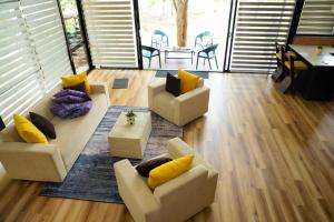 a living room with two couches and a table at Life of Leisure Wilpattu in Pahala Maragahawewa