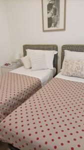 two beds sitting next to each other in a bedroom at dimora Spine Bianche in Matera