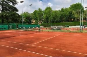 a tennis court with a net on a court at Luxury Verona Apartment City Centre in Verona