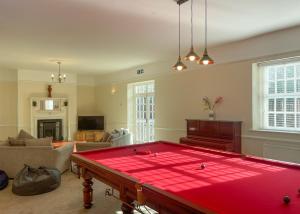 a living room with a large red pool table at Haveringland Hall in Cawston