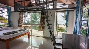 a room with a bed and a ladder in it at Surya cafe and stay sea view in Gokarna