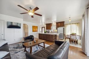 a living room with a couch and a ceiling fan at Charming Retreat on West Quince Street condo in San Diego