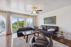a living room with a couch and a table at Charming Retreat on West Quince Street condo in San Diego