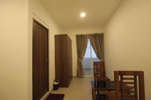 a room with a table and chairs and a window at Hotel Dream Suite, Kattappana in Kattappana