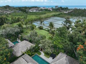 an aerial view of a resort with trees and water at The One Boutique Villa & Spa Seminyak in Seminyak