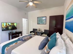 a bedroom with a bed and a flat screen tv at Lovely Apartment #3 in Venetian Site in Turtle Cove