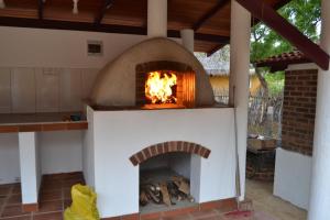 an outdoor oven with a fire in it at Nirukthie Beach Resort & Restaurant in Kalpitiya