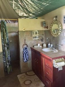 a bathroom with a sink and a shower at Buffalo's Rest Greenpark-Naivasha in Naivasha