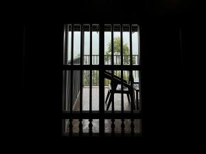a view through a barred window of a staircase at Nature Castle in Kottakamboor