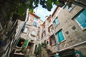 stary budynek z niebieskimi drzwiami i oknami w obiekcie Casa Bachieri w Rovinj