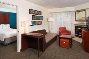 a hotel room with a bedroom with a bed and a desk at Residence Inn San Jose South in San Jose