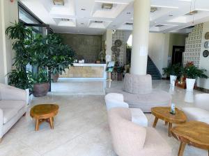 a lobby with couches and tables in a building at KEP BAY HOTEL & RESORT in Kep