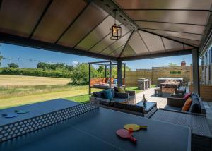 een woonkamer met een tafel en een patio bij Raywell Hall Country Lodges in Skidby
