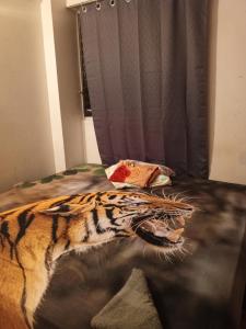 a bed with a tiger patterned comforter on it at Como en Casa in Caracas
