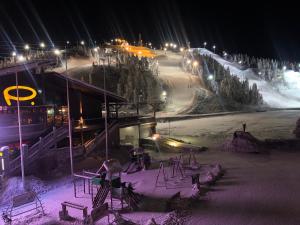 a ski slope at night with snow and lights at Rukanpilke in Ruka