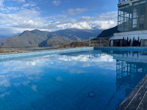 a swimming pool with a view of the mountains at Dhikidada Resort in Pokhara