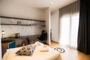 a bedroom with a bed and a large window at AEGLI Central Luxury Apartment in Alexandroupoli