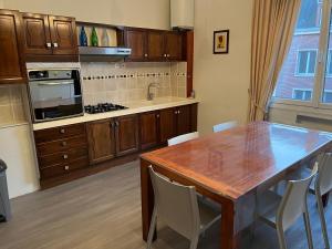a kitchen with a wooden table and a dining room at 3 Cailloux in Amiens