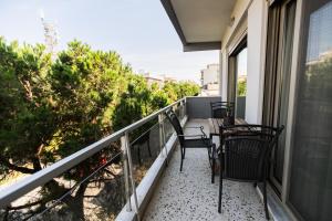 a balcony with two chairs and a table at AEGLI Central Luxury Apartment in Alexandroupoli