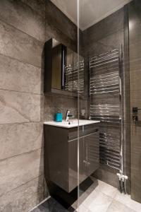 a bathroom with a sink and a shower at AEGLI Central Luxury Apartment in Alexandroupoli +55 photos