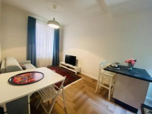 a small living room with a table and a living room at Nuovissimo trilocale in centro : Ca’ Del Mar in Sanremo +10 photos