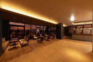 a hotel lobby with chairs and a view of the city at AQA Hotel Premium in Saku +47 photos