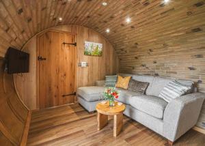 a living room with a couch and a table at Luckington Burrows in Frome