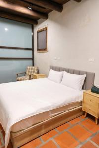 Postel nebo postele na pokoji v ubytování First Floor Inn Kinmen