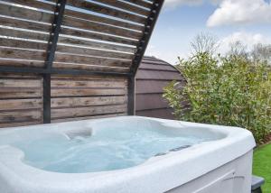 a bath tub sitting in a yard next to a building at Peacock Lake Glamping in East Bridgford